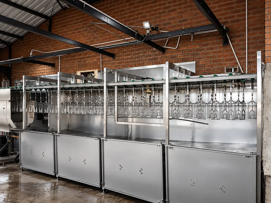 Poultry bleeding, scalding and chiller lines with an overhead line in a processing plant